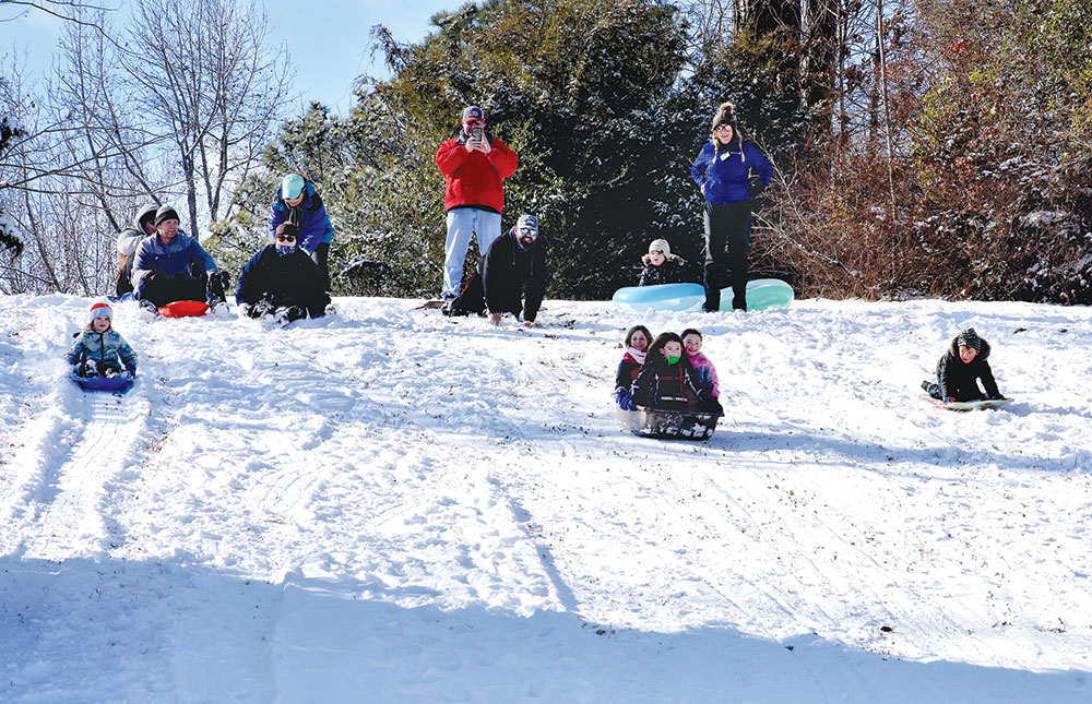 Families gathered throughout Middlesex County on hillsides to sled Saturday