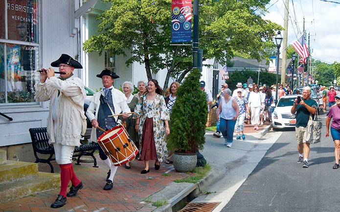 A fife and drum duo leads the way as dozens participate in a procession down Virginia Street in 2025 en route to Urbanna Baptist Church for a special annual Urbanna Founders Day presentation. Folks won’t want to miss this year’s procession — it is expected to start in the mini park adjacent to the colonial courthouse at 210 Virginia St. in Urbanna and wind through the streets of downtown Urbanna to Urbanna Baptist Church at 121 Watling St. The procession start time is approximately 10:30 a.m. Saturday, Aug. 1. (Photo by Don Richeson)